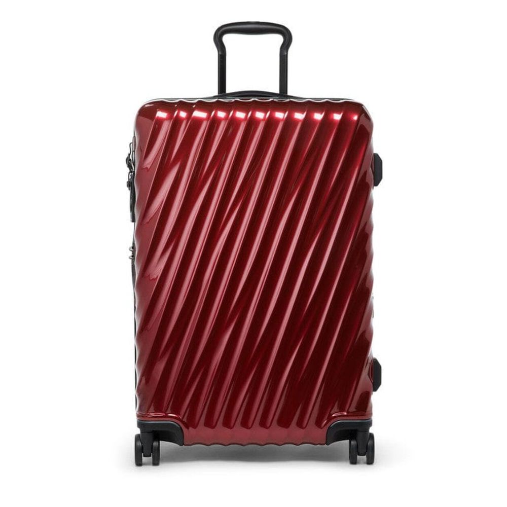 Red suitcase with a textured surface on a white background