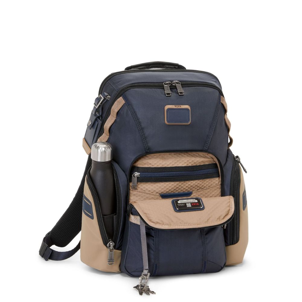 Navy and beige backpack with multiple compartments on a white background