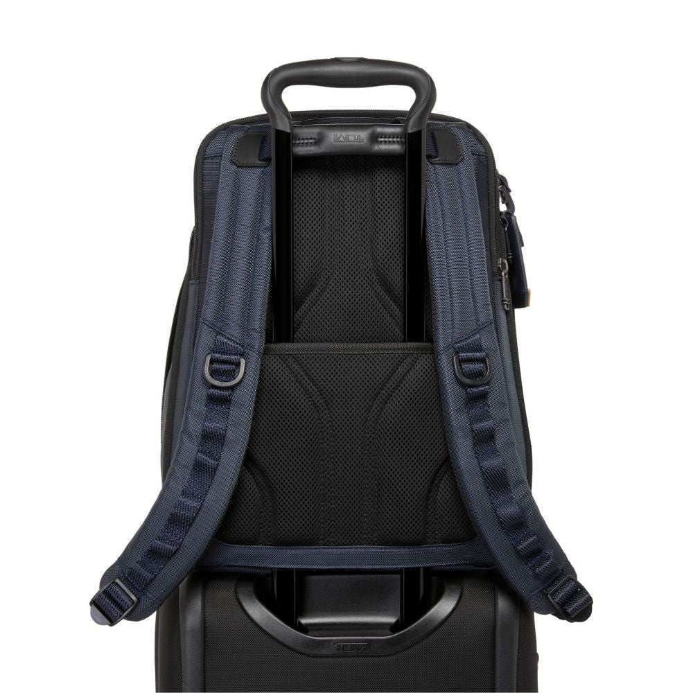 Backpack attached to a suitcase on a white background