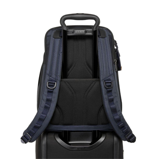 Backpack attached to a suitcase on a white background