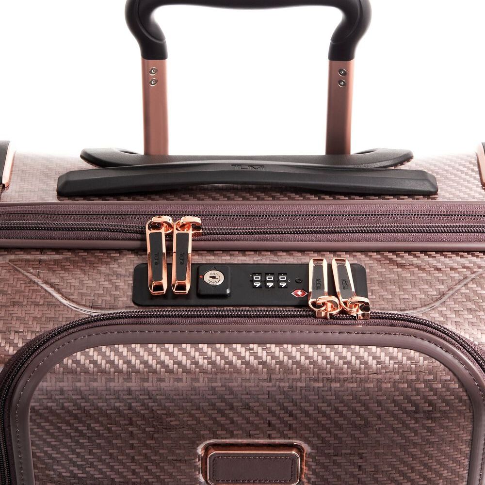 Close-up of a suitcase with a focus on the handle and zipper area.