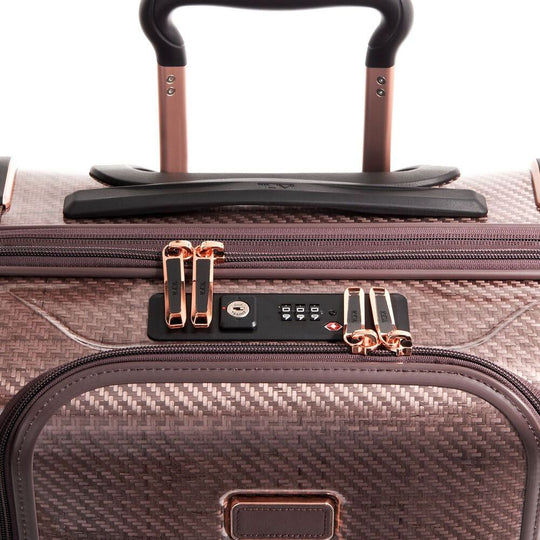 Close-up of a suitcase with a focus on the handle and zipper area.