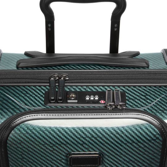 Close-up of a teal suitcase with a black handle and zipper details.