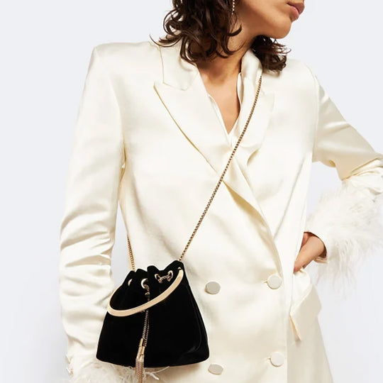 Model in Jimmy Choo Black Bucket Bag with Golden Cross-Body Strap